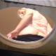 A plump, blonde German girl takes a piss and a hard, wide, chunky shit into a makeshift outhouse box for bowlcam style, visible poop and piss action. Over 2 minutes.